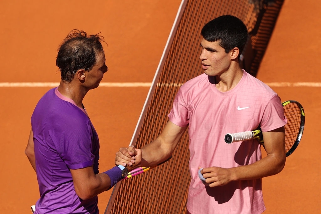 MADRID, SPAIN - MAY 05: Rafael Nadal of Spain shakes hands with Carlos Alcaraz of Spain after winning their second round match during day seven of the Mutua Madrid Open at La Caja Magicaon May 05, 2021 in Madrid, Spain. (Photo by Clive Brunskill/Getty Images)