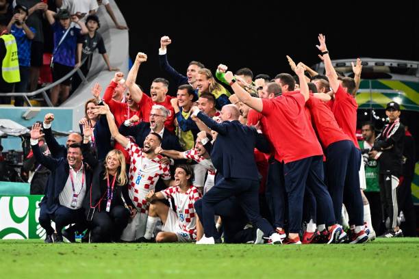 Croatia's players and teammembers celebrate at the end of the Qatar 2022 World Cup Group F football match between Croatia and Belgium at the Ahmad Bin Ali Stadium in Al-Rayyan, west of Doha on December 1, 2022. (Photo by Chandan KHANNA / AFP) (Photo by CHANDAN KHANNA/AFP via Getty Images)